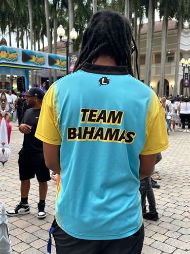 Participant-showing-off-Team-Bahamas-Shirt-at-event