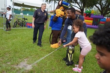 Child-enjoying-demonstration-with-firefighters