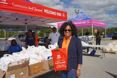 Commissioner-Cherasard-joins-volunteers-and-families-for-the-annual-Turkey-Giveaway